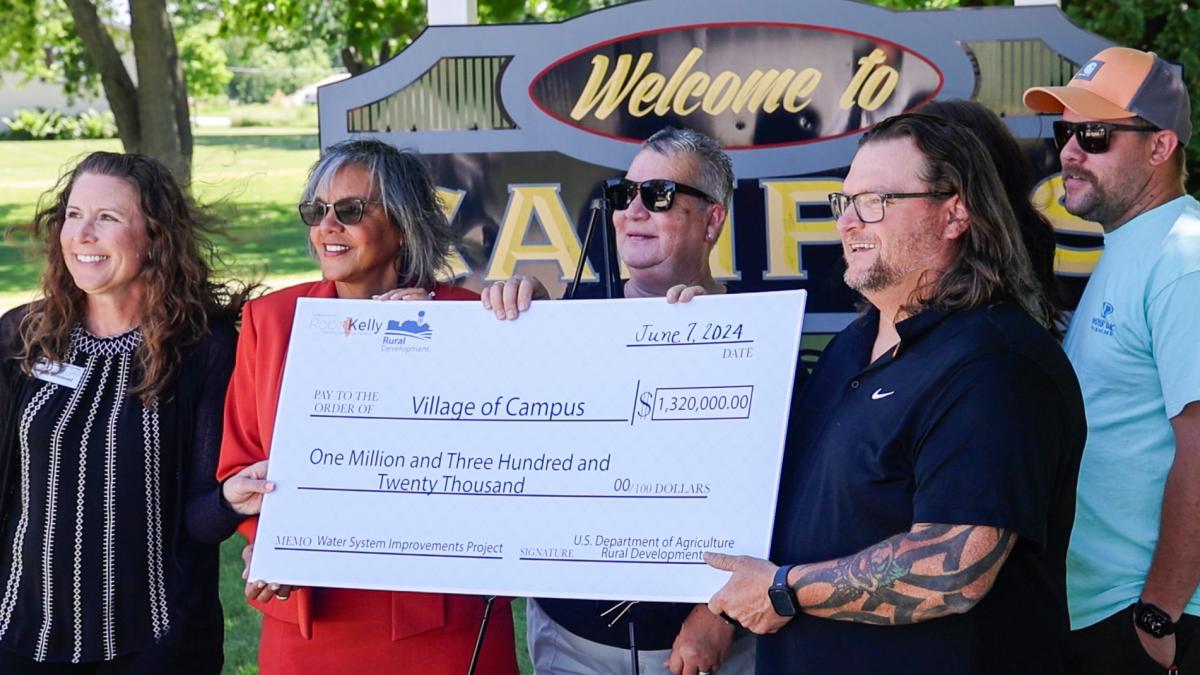 Rep. Kelly presents check to the Village of Campus for water improvements. 