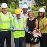 Rep. Kelly and leaders hold a recently removed lead pipe.