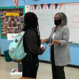 Rep. Kelly talks with a student in a classroom.