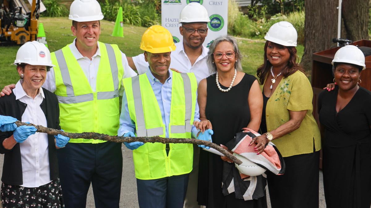 Rep. Kelly and leaders hold a recently removed lead pipe. 